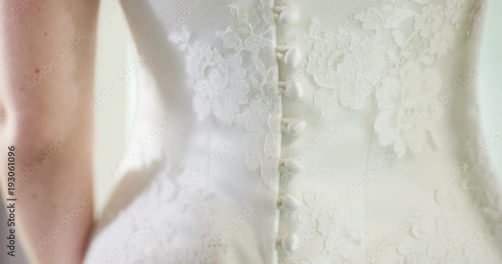 4K Unrecognizable bride trying on her gown in wedding dress store, close up on the detailing of the gown 4K Unrecognizable bride trying on her gown in wedding dress store, close up on the detailing of the gown