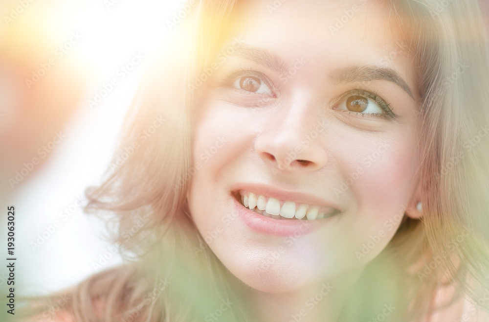 portrait of smiling woman face on blurred background. portrait of smiling woman face on blurred background.