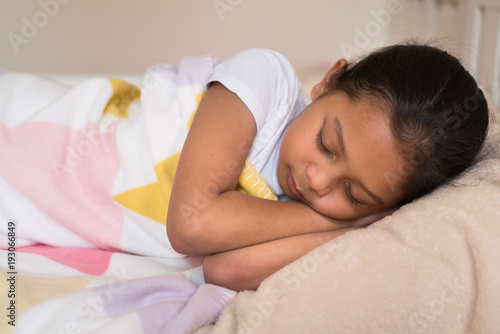 young little asian girl sleeping lying on bed in her bedroom. sleep concept