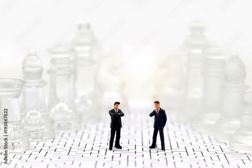 Miniature people: Businessman standing on maze with chess. Concepts of finding a solution, problem solving and challenge. Miniature people: Businessman standing on maze with chess. Concepts of finding a solution, problem solving and challenge.