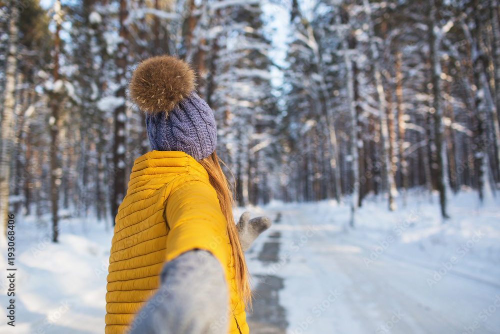 Following to a young girl in a bright clothes standing in a winter forest Following to a young girl in a bright clothes standing in a winter forest