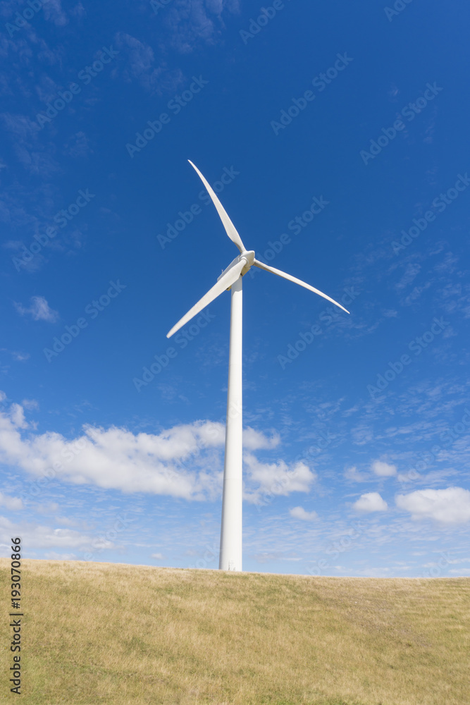 Wind turbine against clear blue sky
