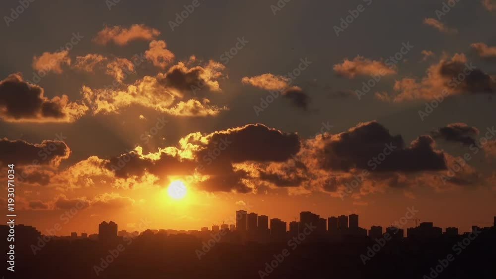 Beautiful view of sunset on the cloudy sky over city Beautiful view of sunset on the cloudy sky over city
