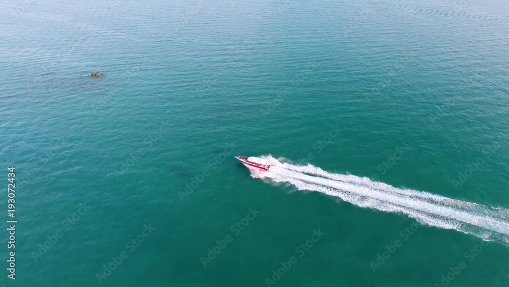 Aerial: Fast Speed boat in Blue Sea Water. Thailand. Aerial: Fast Speed boat in Blue Sea Water. Thailand.