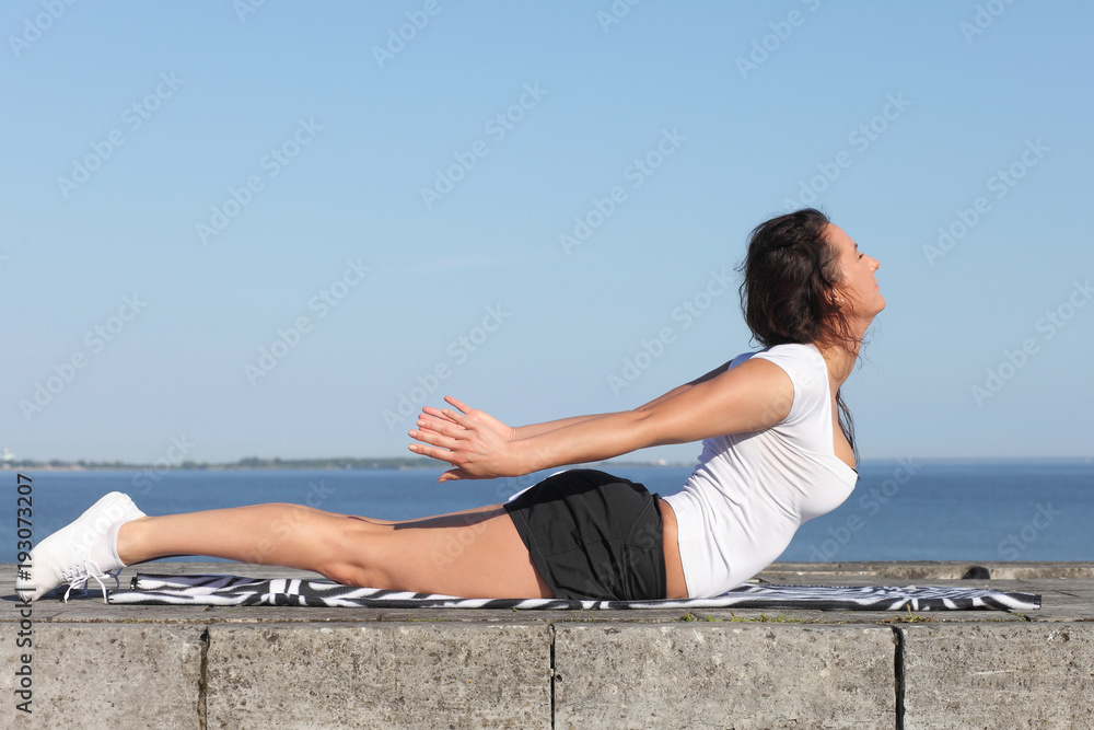 young girl practicing yoga exercises