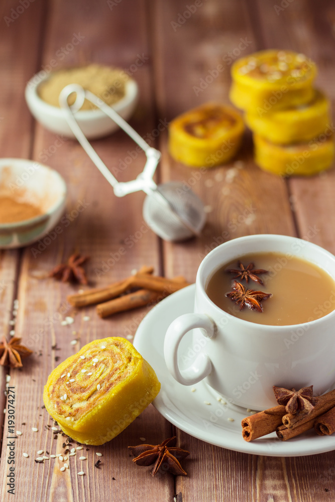 Indian tea masala with spices in white cup, Indian food on wooden table Indian tea masala with spices in white cup, Indian food on wooden table