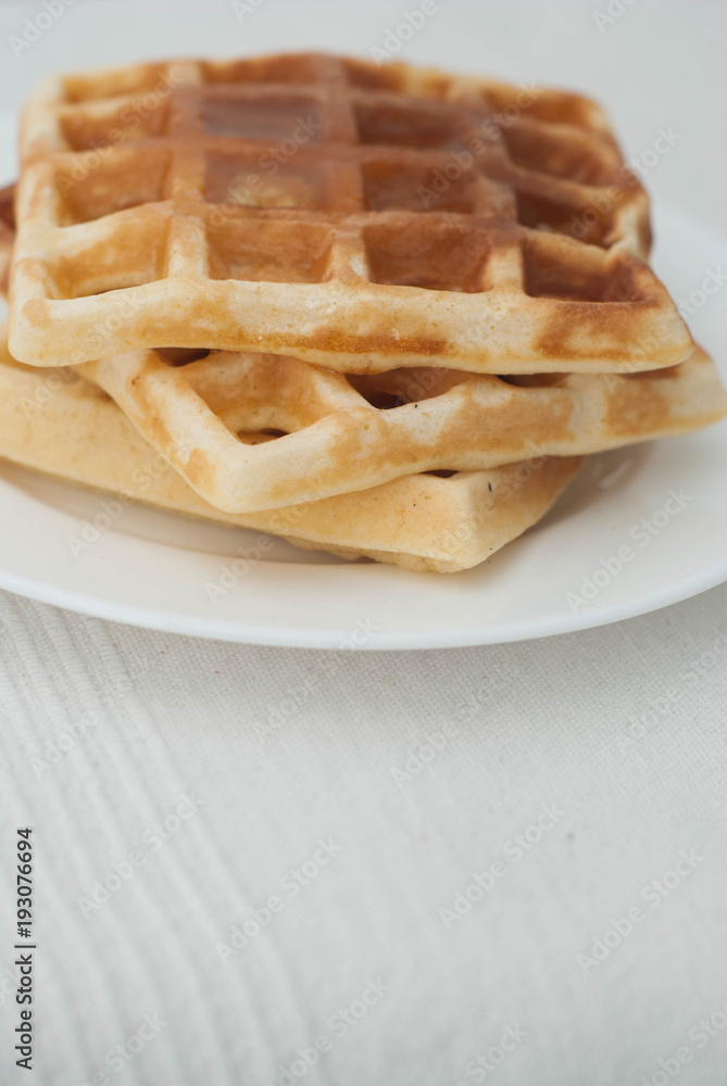 Belgian Homemade Waffles on White with Copy Space. Delicious Pancakes. Breakfast or Dessert. Belgian Homemade Waffles on White with Copy Space. Delicious Pancakes. Breakfast or Dessert.