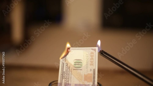 One Hundred Dollars Burning Through Finanaces and Cash photo