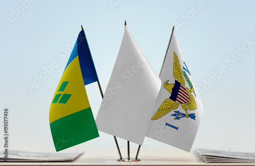 Flags of Saint Vincent and the Grenadines and U.S. Virgin Islands with a white flag in the middle photo