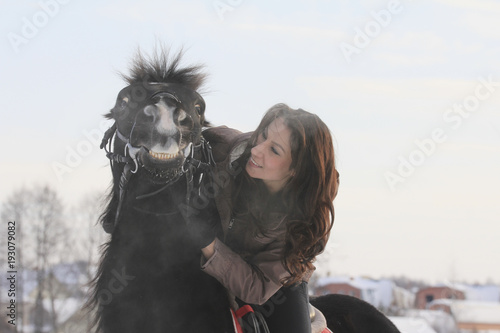 Young black hair woman with a horse