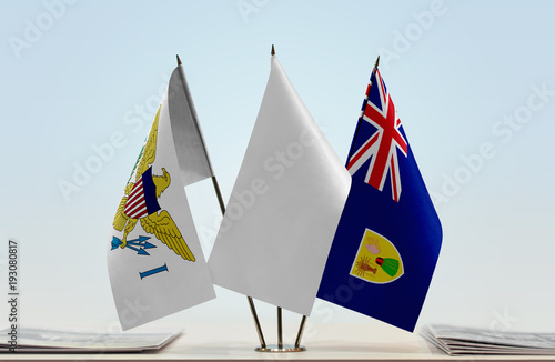 Flags of U.S. Virgin Islands and Turks and Caicos Islands with a white flag in the middle photo