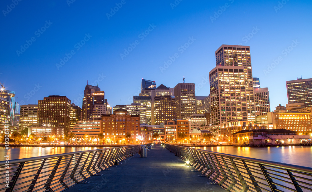 Illuminated San Francisco cityscape at night from the Embarcadero pier