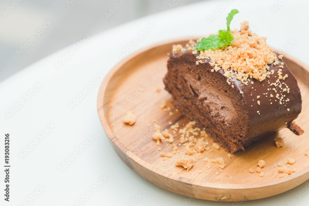 good taste dessert with chocolate roll cake on wood dish of copy space good taste dessert with chocolate roll cake on wood dish of copy space