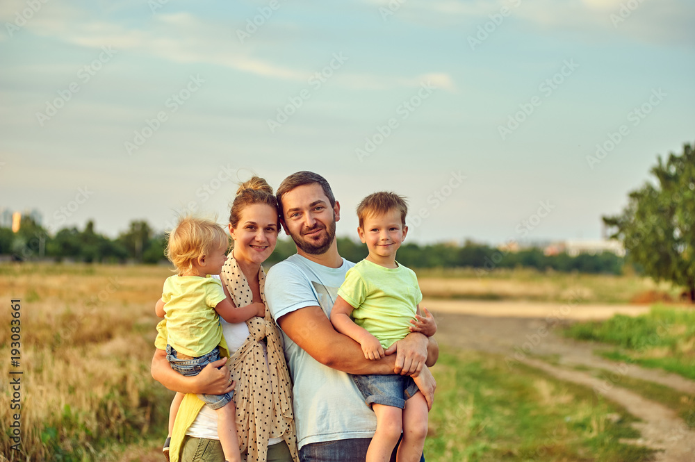 young married couple with children on a country walk