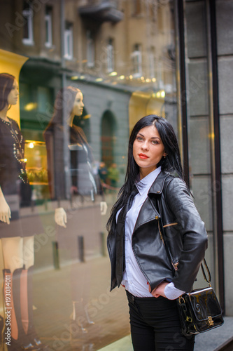 Shopping business woman in a city,Europe city streets . Lady in morern suit wearing fashionable clothes , concept of sale and shopping, outdoors.   photo