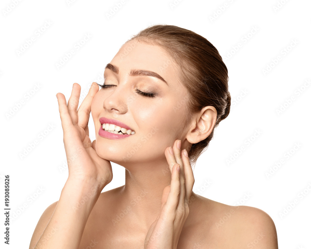 Portrait of beautiful young woman with clear skin on white background