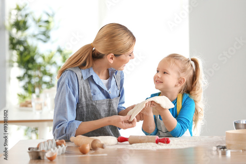 Mother and daughter with do...