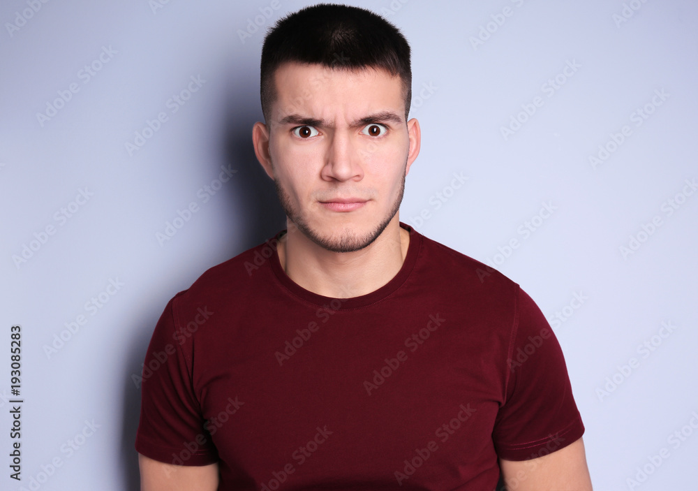 Emotional young man with dyed eyebrows on light background Emotional young man with dyed eyebrows on light background