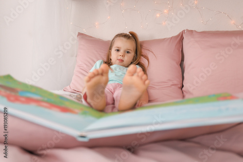 Cute little girl with book ...