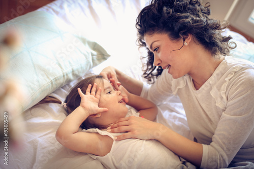 Single mother at morning with her little girl.