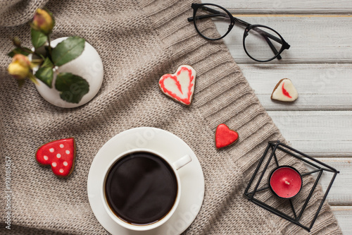 Box with a present to the Valentine's Day cookies in the shape of a heart and cups of black coffee photo