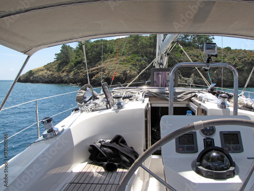Yacht sailing near a coastline of a Island. Adriatic sea of Mediterranean area. Croatian riviera. Dalmatian region. Yacht-charter. Rest on a water. Holidays on a sea. Yachting regatta and cruise. 