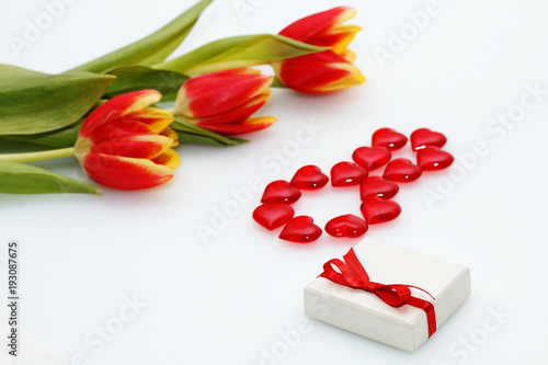 Fototapeta Naklejka Na Ścianę i Meble -  Card on March 8 - International Women's Day: Three red tulips present with a bow and number 