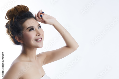 Happy beautiful asian girl with the fresh skin on white background. Expressive facial expressions. Cosmetology and Spa concept.