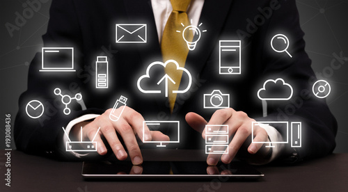 Quadro su tela Businessman in suit typing with multimedia concept