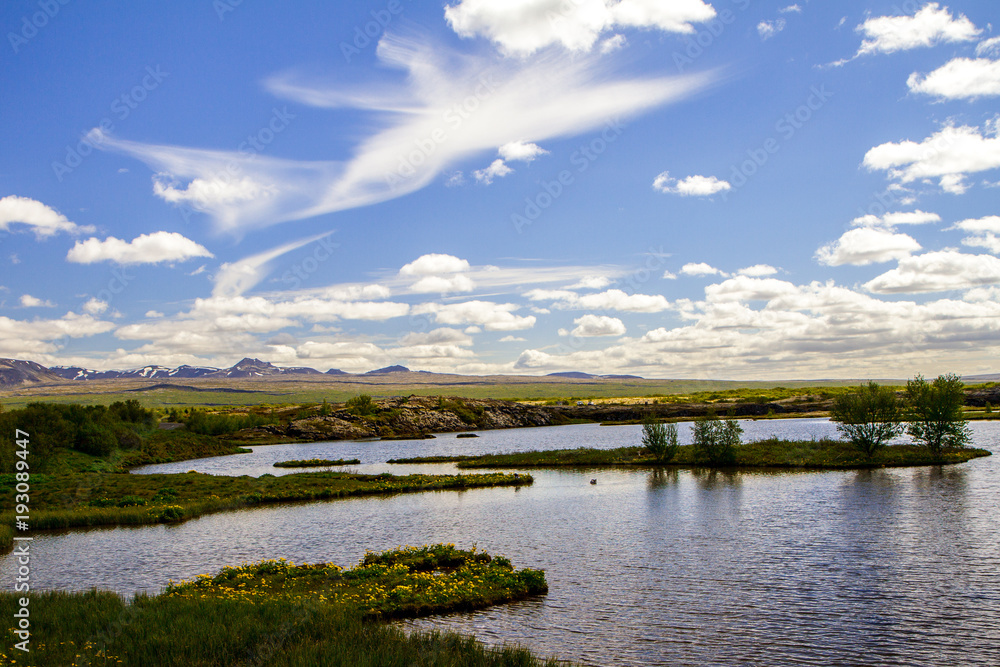 Blue sky with white clouds over the national park. Thingvellir in Iceland 12.06,2017 Blue sky with white clouds over the national park. Thingvellir in Iceland 12.06,2017