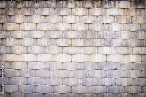 Grey textured brick wall.