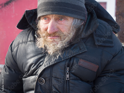unemployed man sitting on a bench in the winter day