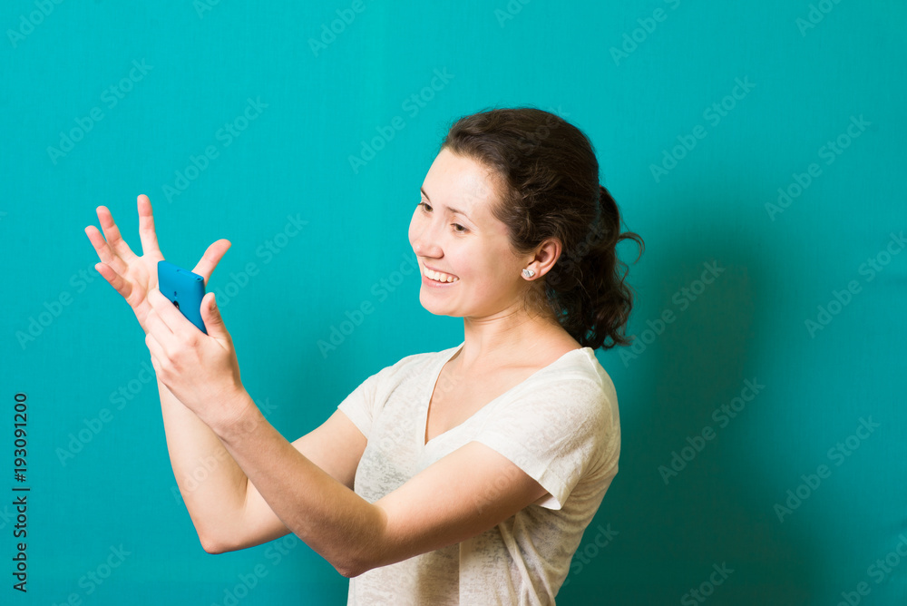 Fototapeta premium the girl is happy with the phone