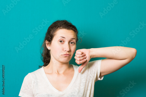 Girl showing thumbs down photo