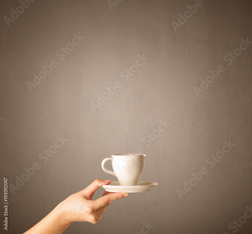Female hand holding coffee cup