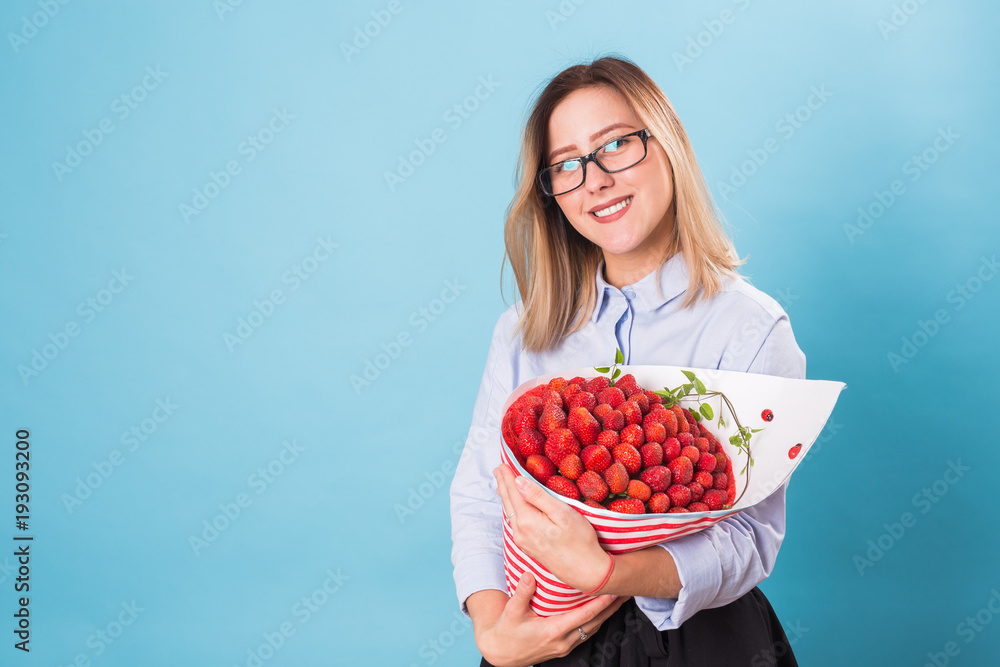 Beautiful woman holding bouquet made of strawberry Beautiful woman holding bouquet made of strawberry