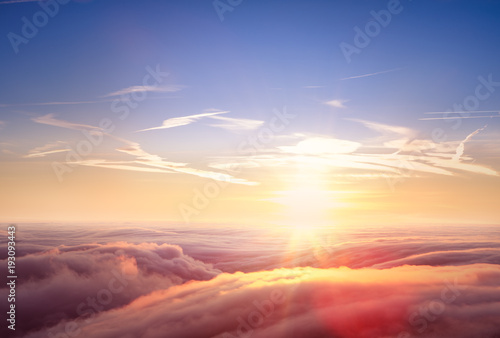 Fototapeta Naklejka Na Ścianę i Meble -  Beautiful aerial view above clouds with sunset.