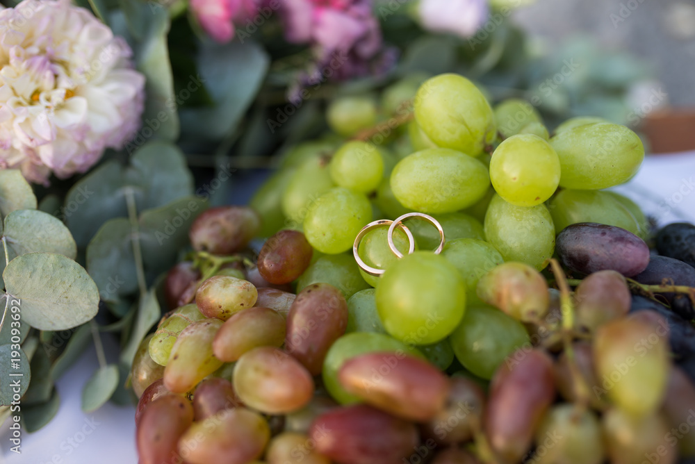 Gold wedding rings lie on the grape. Wedding Gold wedding rings lie on the grape. Wedding