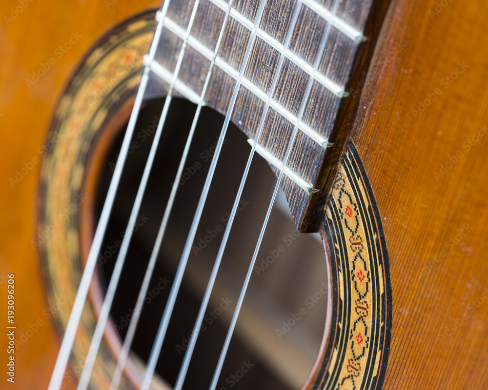 Obraz premium closeup of hole in spanish classical guitar and snares