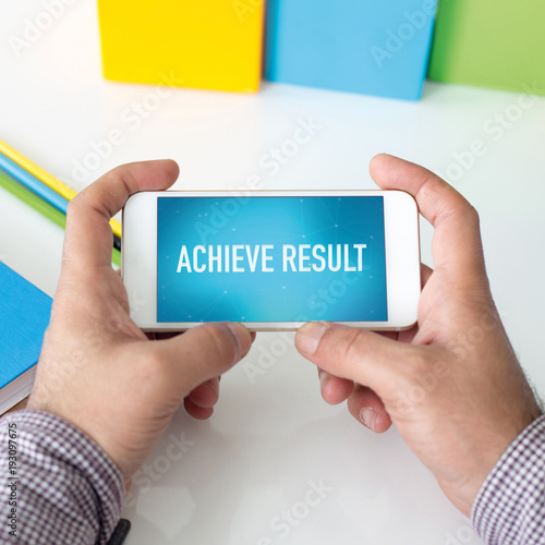 Man holding smartphone which displaying Achieve Result