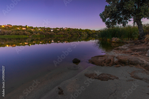 Colorful twilight water reflections in Embalse Cerro Alarcon (Cerro Alarcon Reservoir) of the Perales River. Located between Valdemorillo and Navalagamella, Madrid, Spain. photo