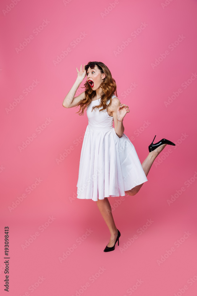 Adorable caucasian woman in white dress taking off sunglasses and looking aside on copyspace with surprise, isolated over pink background Adorable caucasian woman in white dress taking off sunglasses and looking aside on copyspace with surprise, isolated over pink background