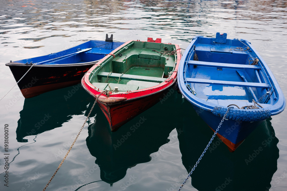 Three colorful wooden boats