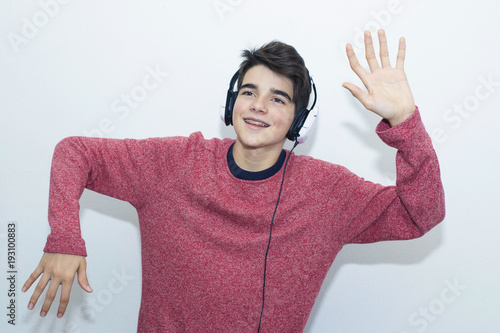 teen with headphones dancing on white background photo