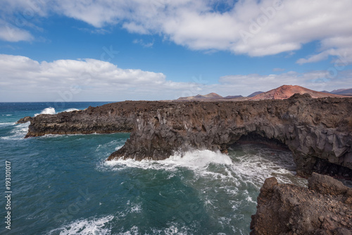 Lanzarote landscape. Los Hervideros coastline, lava caves, cliffs and wavy ocean. No people appears in the scene.