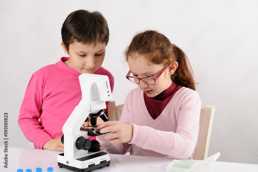 schoolgirls with modern microscope schoolgirls with modern microscope