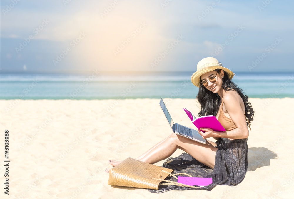 woman using laptop computer on the beach. Freelance work concep vacation on the beach