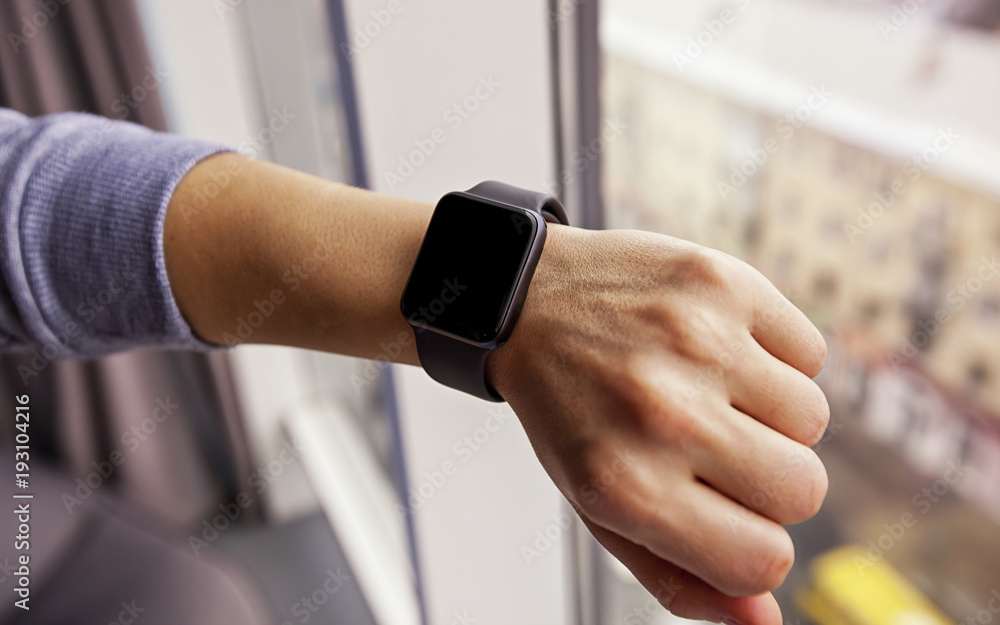The modern smart watch on the woman's hand