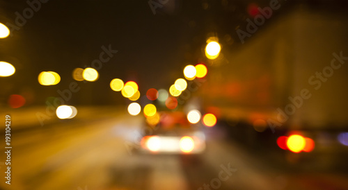 View of blurred road with lots of cars and light from the driver's eyes