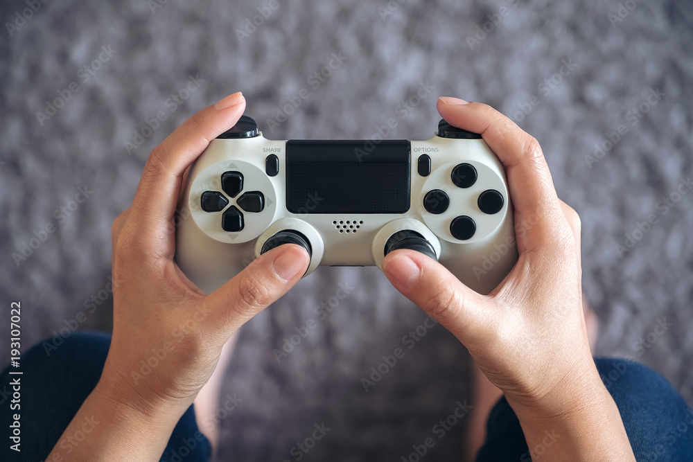 Top view image of hands holding the game controller while playing games Top view image of hands holding the game controller while playing games